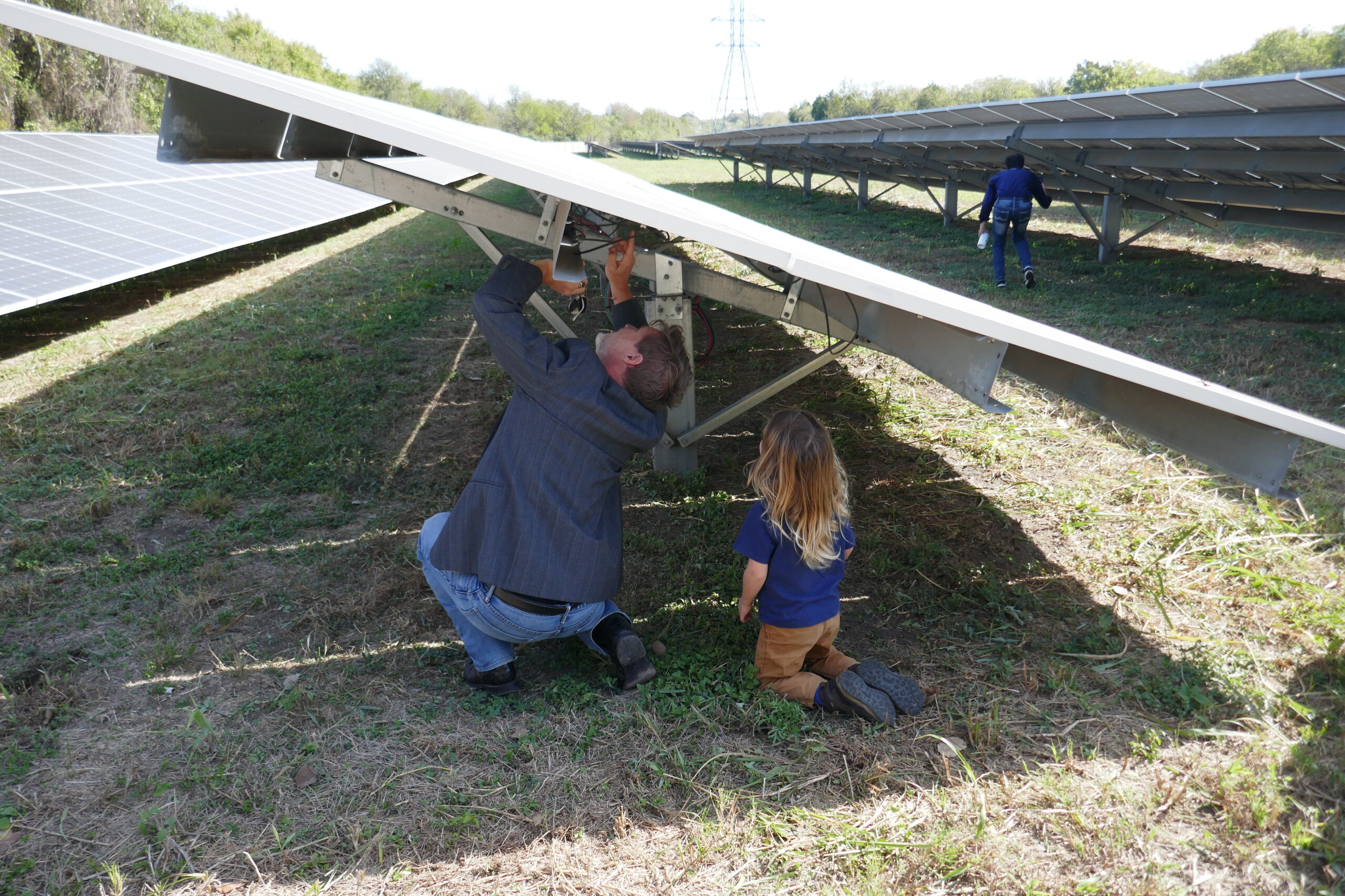 A man and a child trying to fix a solar panel