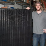 Jay Thomas holding a solar panel