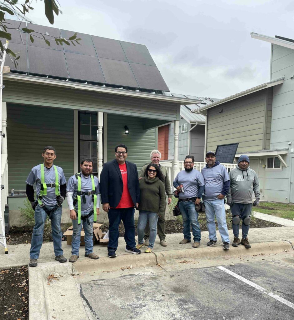 A team of GNDC East Knight House along with Solar Austin is posing for a photograph post solar panels installation.
