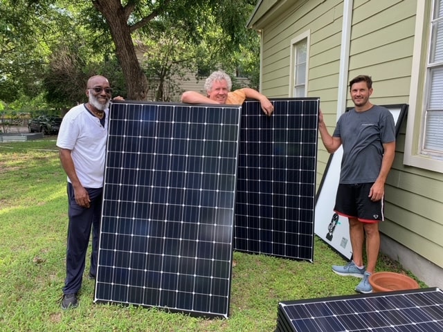 Kenneth Thompson with 2 volunteers working on Solar panel